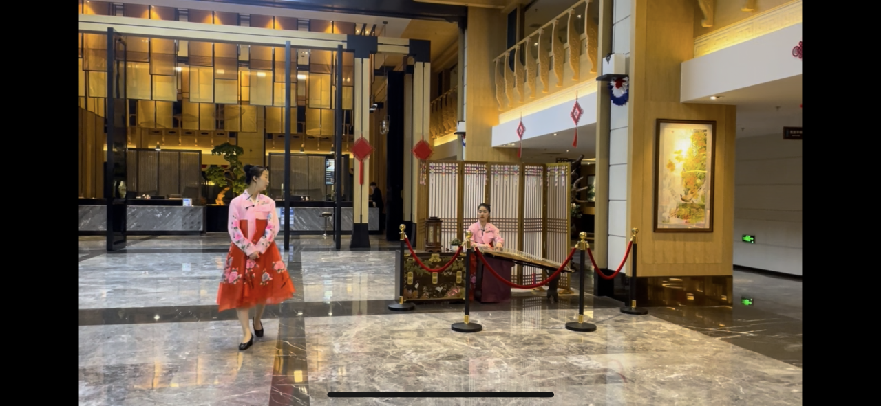 Korean girls playing the traditional Korean instrument Gayageum at the Hunchun National Garden International Hotel.