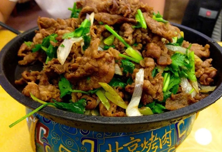 Traditional Beijing cuisine - grilled meat on a hot plate